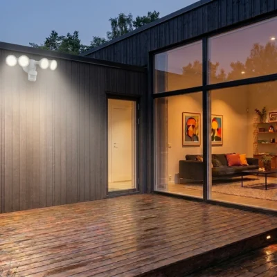 Outdoor motion sensor light installed above a modern home's driveway